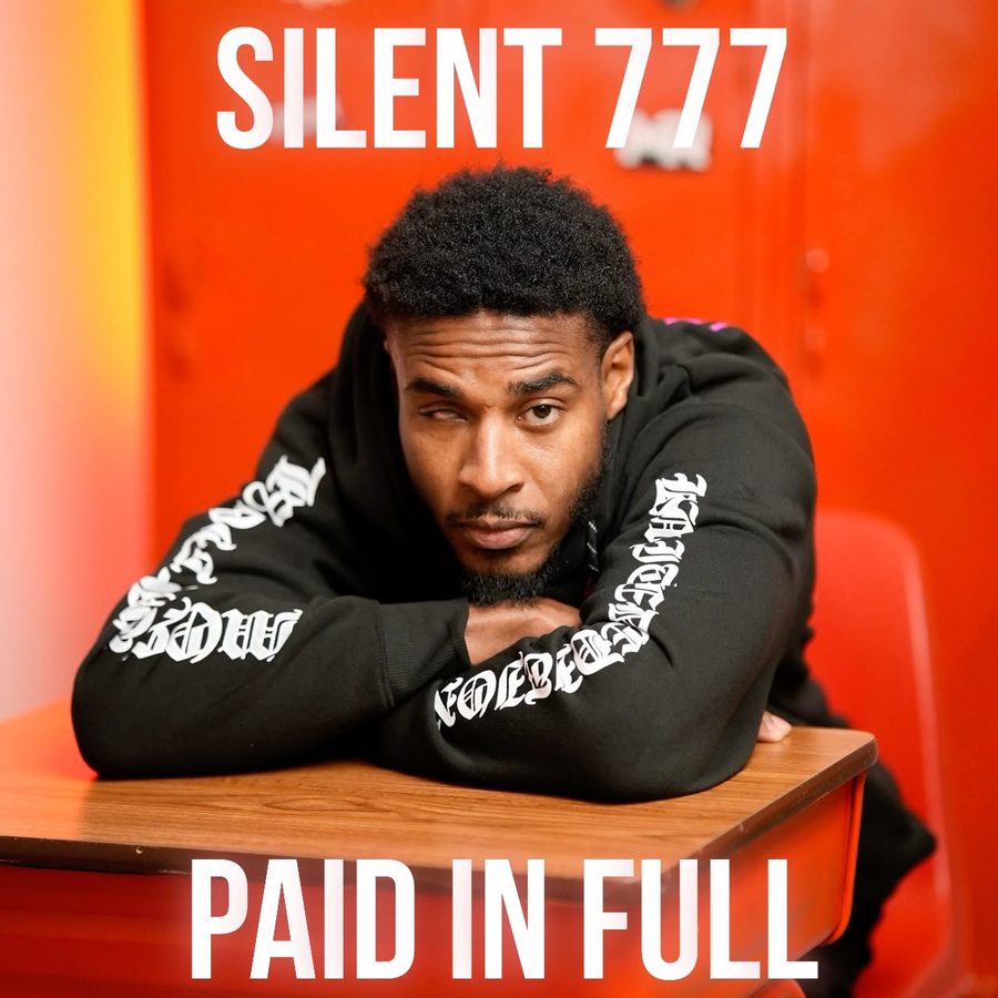 Cover art for Paid in Full: Silent 777 leaning on a school desk in front of red lockers.
